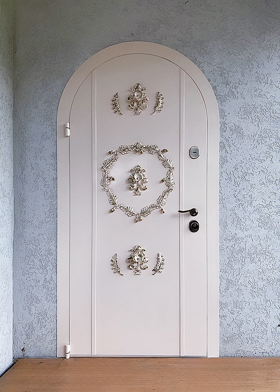 Арочная белая дверь с ковкой